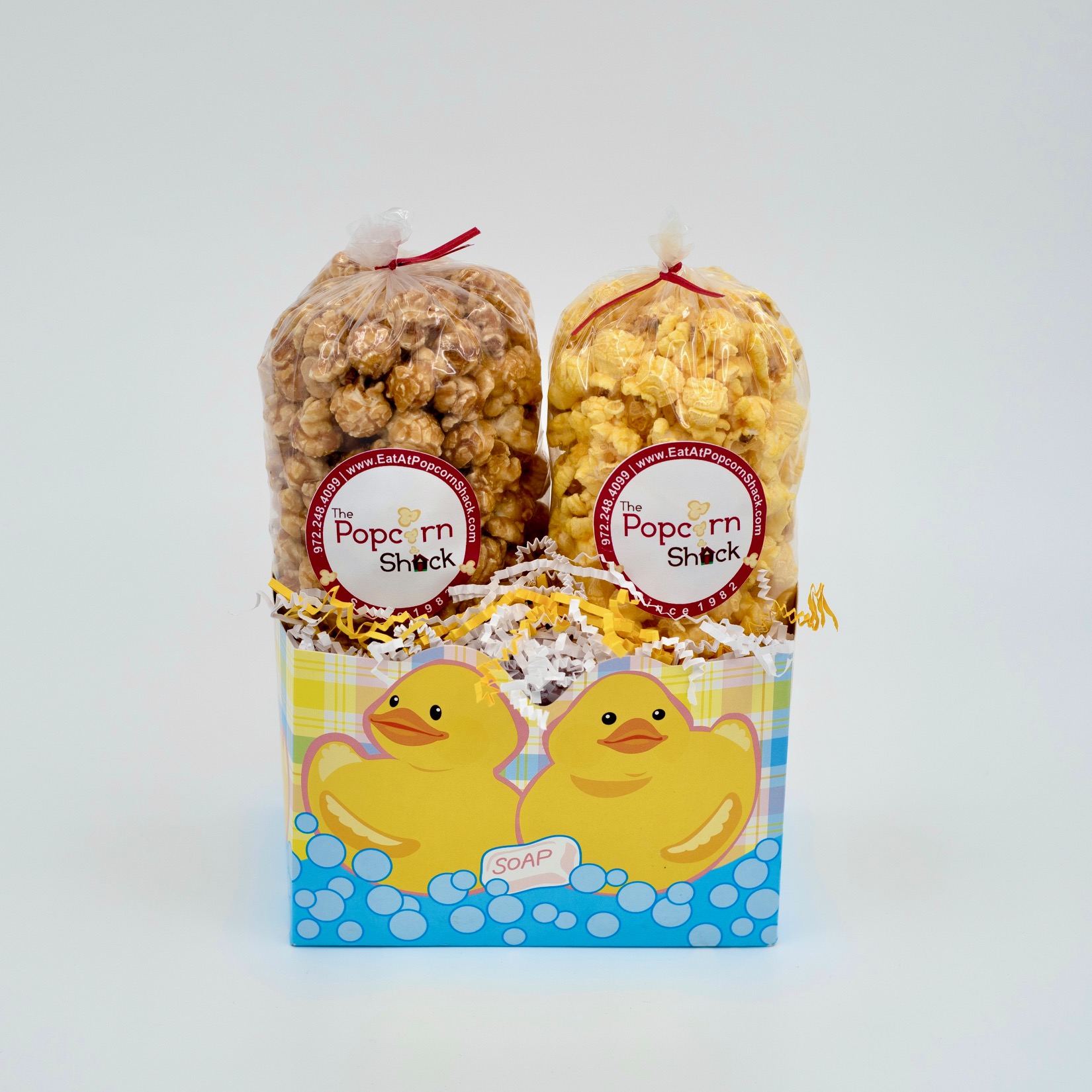 Gift basket with baby bath ducks in water with soap.