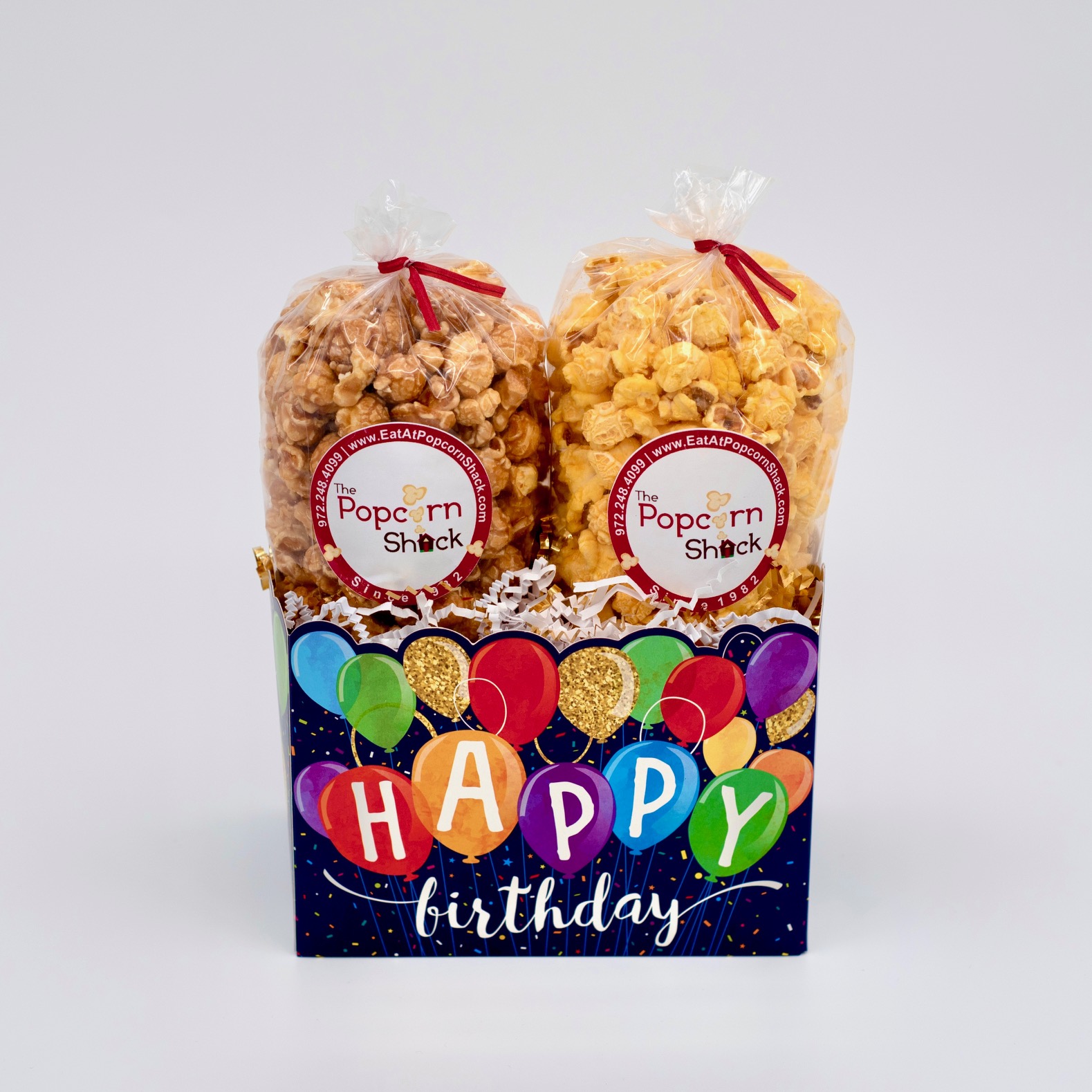 Multi-colored balloons on a gift basket with the words "happy birthday". Big enough for two bags of your choice of popcorn.