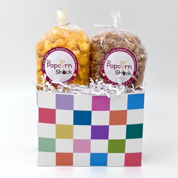 Two bags of popcorn in a white box with pastel checkered squares